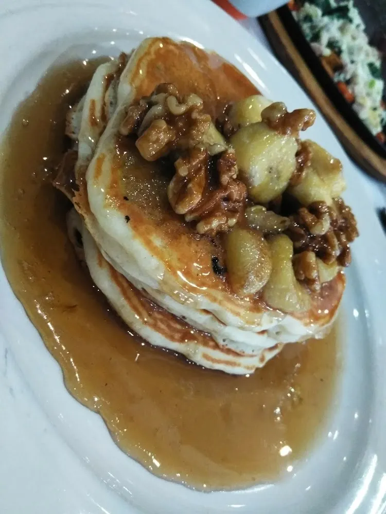 Bananas Foster Pancakes with a Drizzle of Banana Walnut Syrup